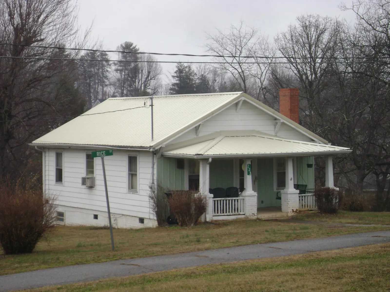 White metal roof on a craftsman bungalow at a street corner in Island Park